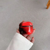 Coque AirPods LUCIØLE Rouge — de jour, translucide